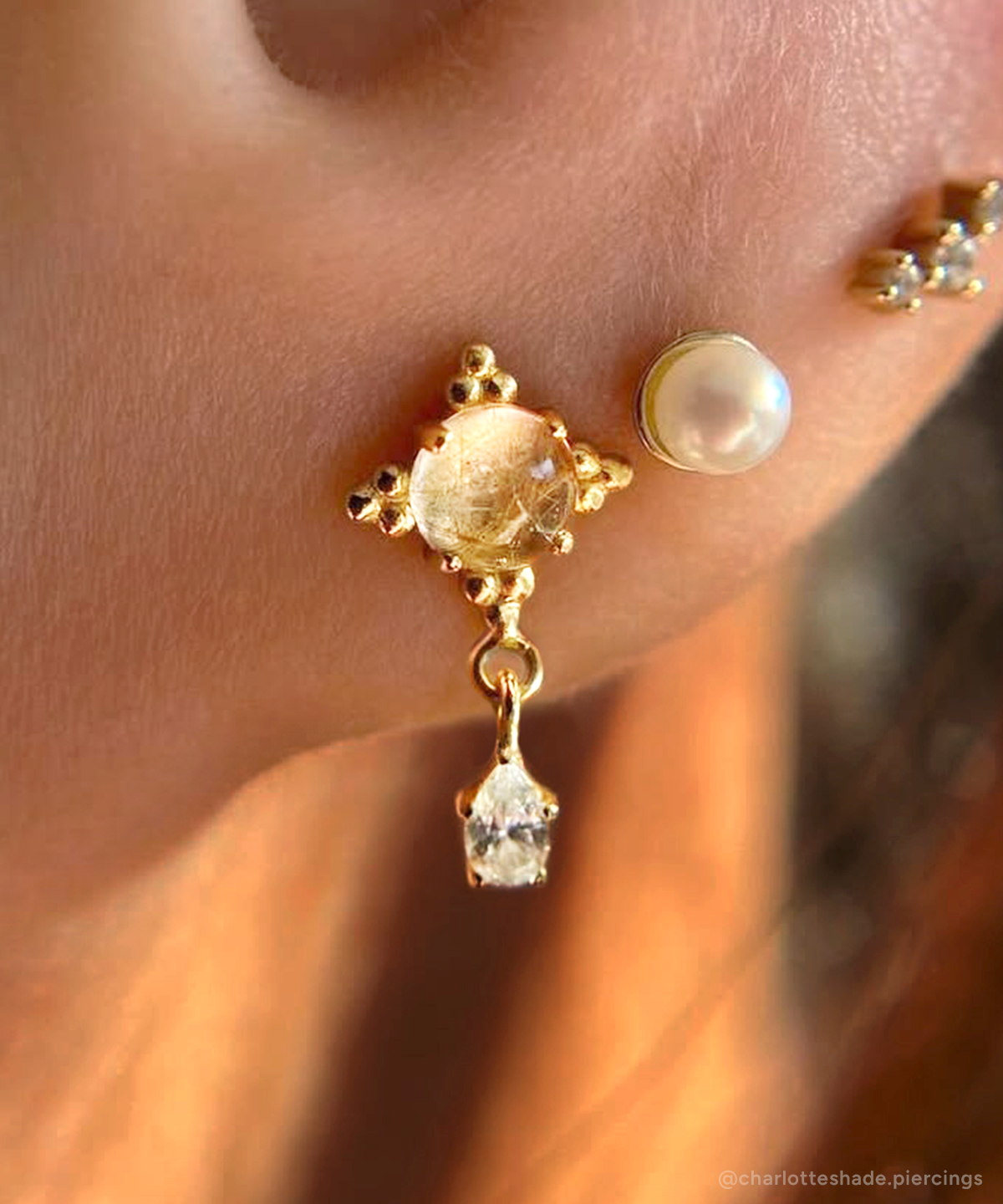 Lobe piercing featuring Zia dangle with Rutilated Quartz and CZ