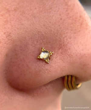 Nostril piercing feature a Zia End with a Rainbow Moonstone gem.