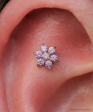 Yellow gold Flower end with Amethyst gemstones in a flat helix piercing.
